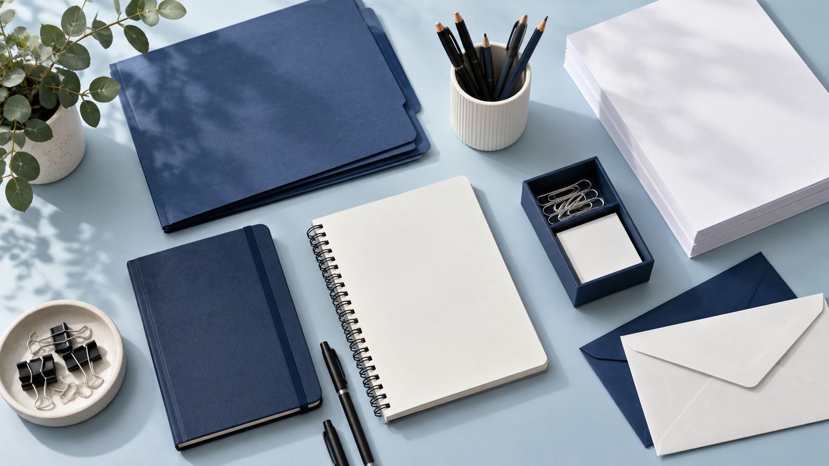 Conceptual overhead arrangement of unbranded stationery, folders and paper